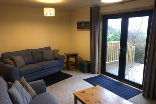 living room apartment 1 with access to outside deck and garden